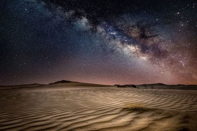 Scenic view of beach against sky at night