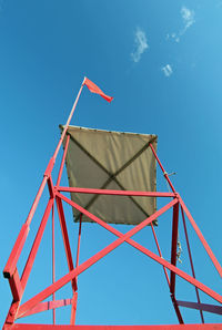 Big turret of lifeguard on the beach with the red flag to signal the danger