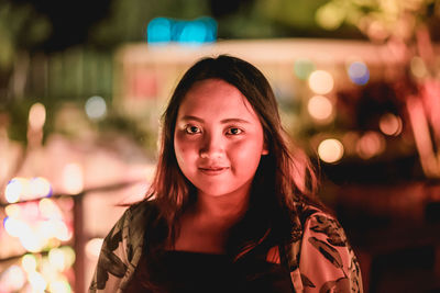 Portrait of smiling young woman standing outdoors