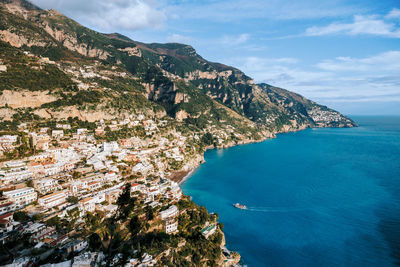 High angle view of townscape by sea against sky