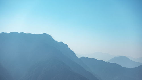 Scenic view of mountains against clear blue sky