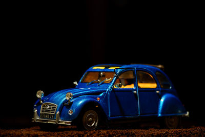 Toy car against black background