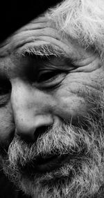 Close-up portrait of man against black background