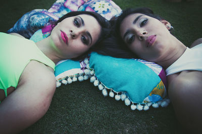 Portrait of friends lying on field