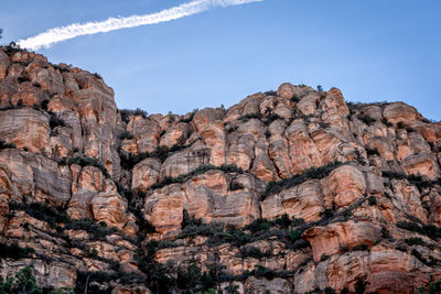 Low angle view of rock formations against sky