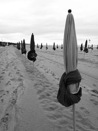 Rear view of people relaxing on beach