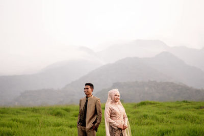 Portrait of a young man standing on mountain