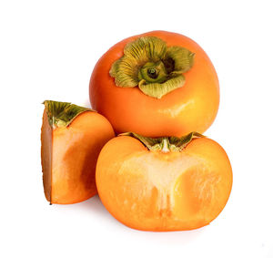 Close-up of orange fruit against white background