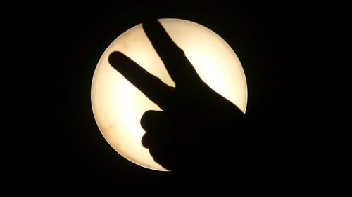 Close-up of lamp over black background