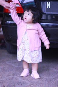 Full length of cute girl standing in car
