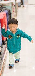 Portrait of cute boy standing on floor