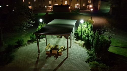 Empty bench in park at night