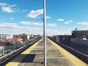 Railroad track against cloudy sky