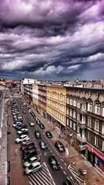 High angle view of city street against cloudy sky