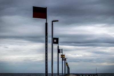 Low angle view of street light against cloudy sky