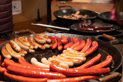 Different grilled sausages on a large skillet.