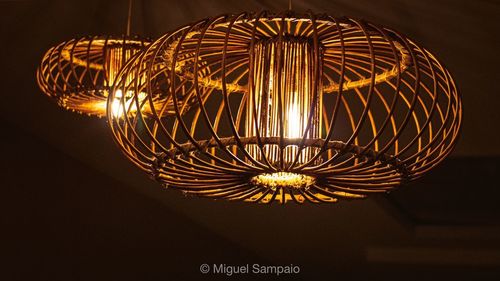 Low angle view of illuminated light bulb in the dark