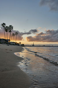 Scenic view of beach against sky during sunset