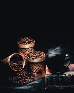 Close-up of coffee cup on table against black background