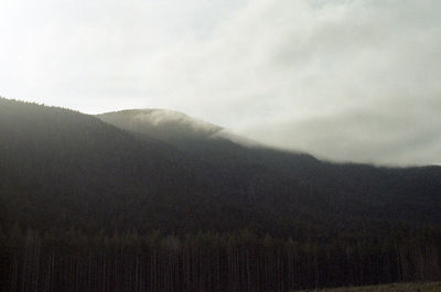 Scenic view of mountains against cloudy sky