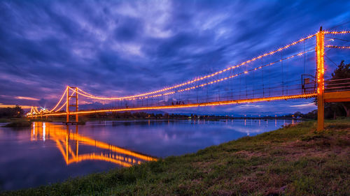 Golden gate bridge over river against cloudy sky