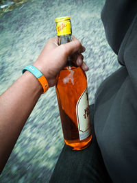 Close-up of hand holding bottle