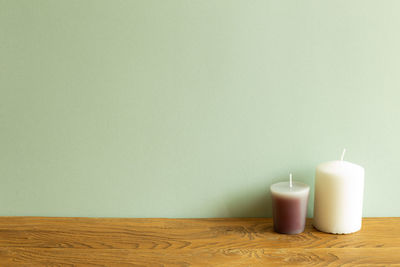 Close-up of drink on table against wall