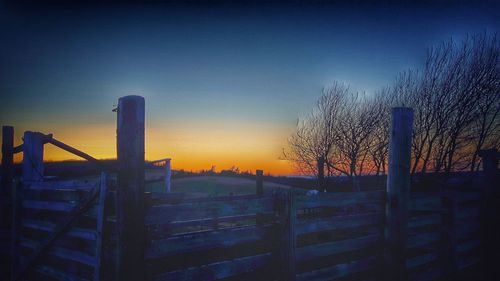 Scenic view of landscape against clear sky during sunset