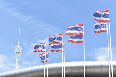 Low angle view of flags flag against sky