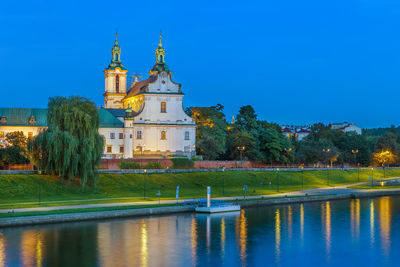 View of st. stanislaus church at skalka from vistula river in evening, krakow, poland