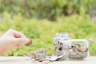 Close-up of hand holding crystal ball on table