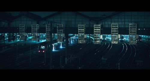 Railroad tracks in city at night