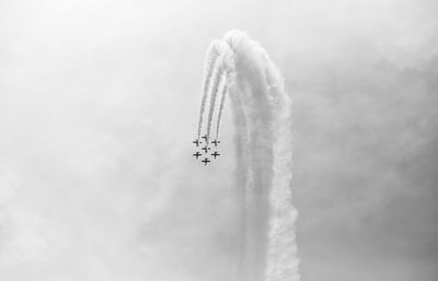 Low angle view of airshow against sky