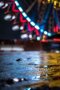 Surface level of wet illuminated street in rainy season