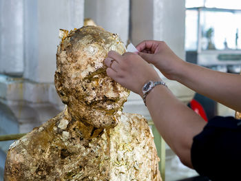 Close-up of woman holding ice cream on table