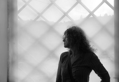 Close-up of woman standing against white background