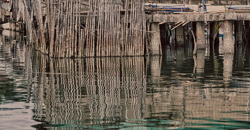 Wooden pier on lake by old building