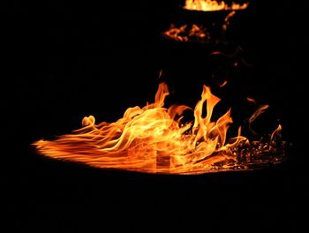 Close-up of bonfire against black background