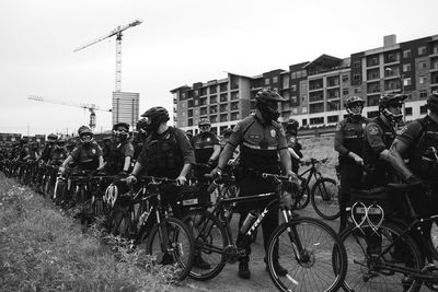 People on street in city against clear sky