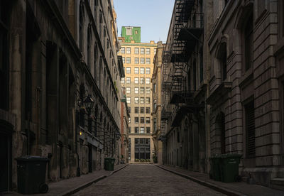 Street amidst buildings in city against sky