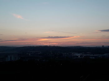 Silhouette buildings against sky during sunset
