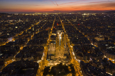 High angle view of illuminated cityscape against sky during sunset