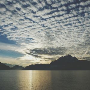 Scenic view of mountains against cloudy sky