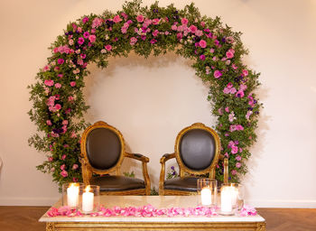 Empty chairs by pink flower decorations