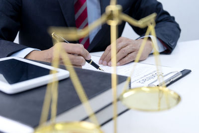 Close-up of man holding umbrella on table