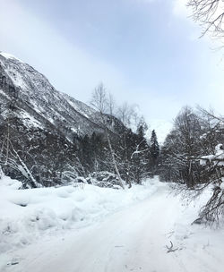 Snow covered field against sky