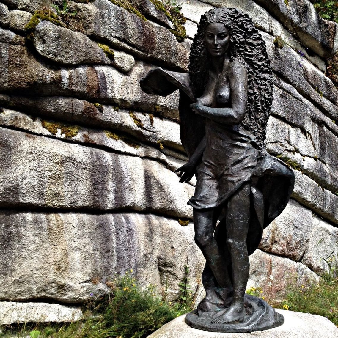 statue, sculpture, human representation, art and craft, art, creativity, stone material, history, carving - craft product, religion, buddha, stone, day, stone wall, outdoors, spirituality, rock - object, low angle view