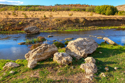 Limestones rocks on the river shore . idyllic summer riverside nature