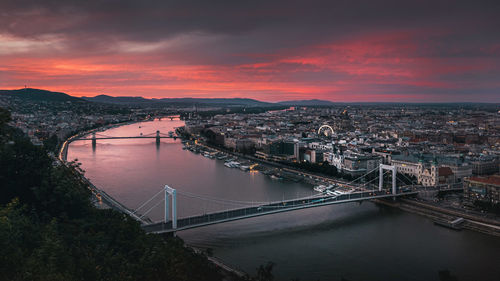 High angle view of suspension bridge over river during sunset