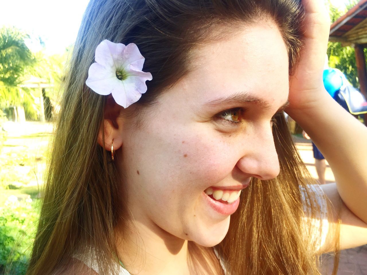 person, headshot, flower, close-up, portrait, lifestyles, human face, leisure activity, focus on foreground, fragility, long hair, beauty, day, cute, petal, casual clothing